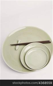 High angle view of chopsticks and plates