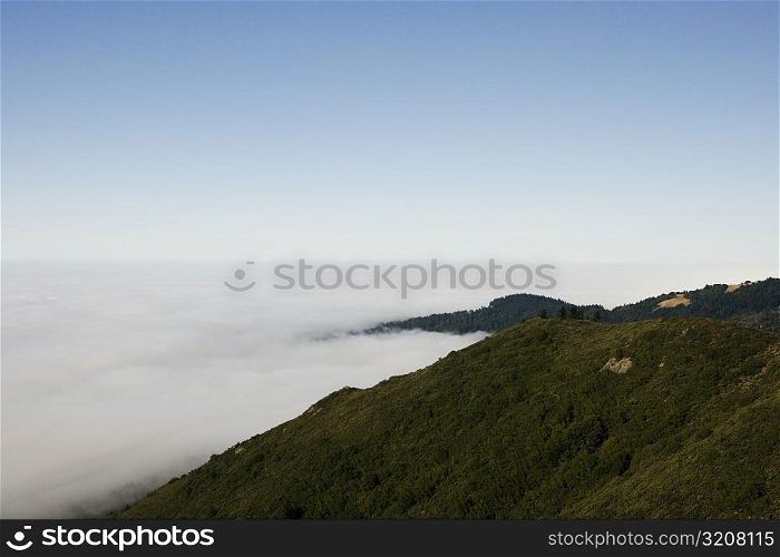 High angle view of clouds around a hill range