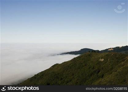 High angle view of clouds around a hill range