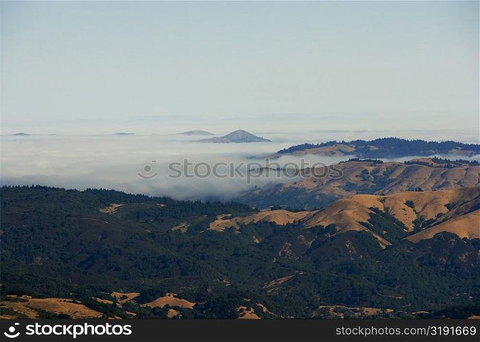 High angle view of clouds over mountains