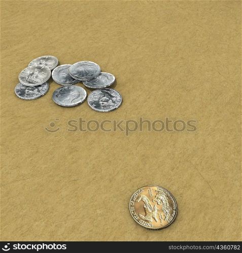 High angle view of coins on sand