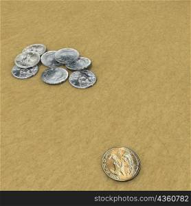 High angle view of coins on sand