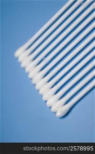 High angle view of cotton swabs on a blue background