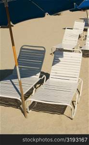 High angle view of empty chairs on the beach