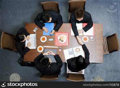 High angle view of five business executives in a meeting