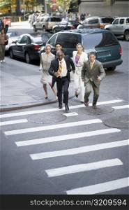 High angle view of five business executives running on the road