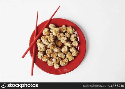 High angle view of food in a plate with a pair of chopsticks