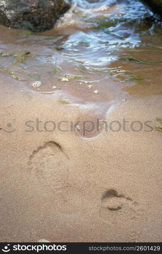 High angle view of footprint of a person in sand