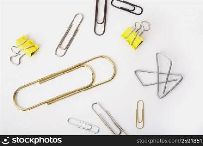High angle view of paper clips and binder clips