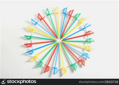 High angle view of plastic toothpicks arranged in a circular pattern
