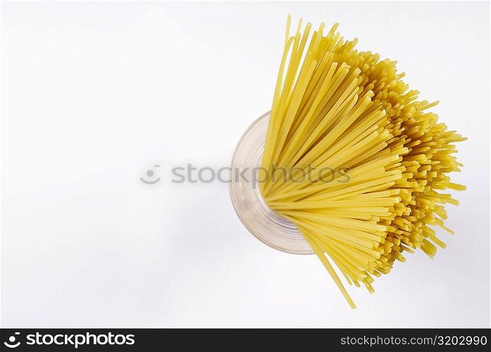 High angle view of raw spaghetti in a glass