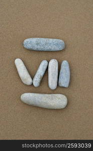 High angle view of Roman numeral created with pebbles