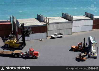High angle view of semi-trucks and forklifts at a commercial dock