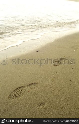 High angle view of shoe prints on the beach