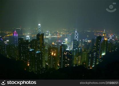 High angle view of skyscrapers lit up at night in a city, Victoria Harbor, Hong Kong Island, Hong Kong, China