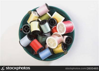 High angle view of spools of threads in a bowl