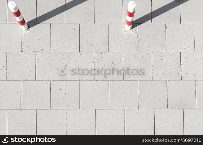 High angle view of striped poles on sidewalk