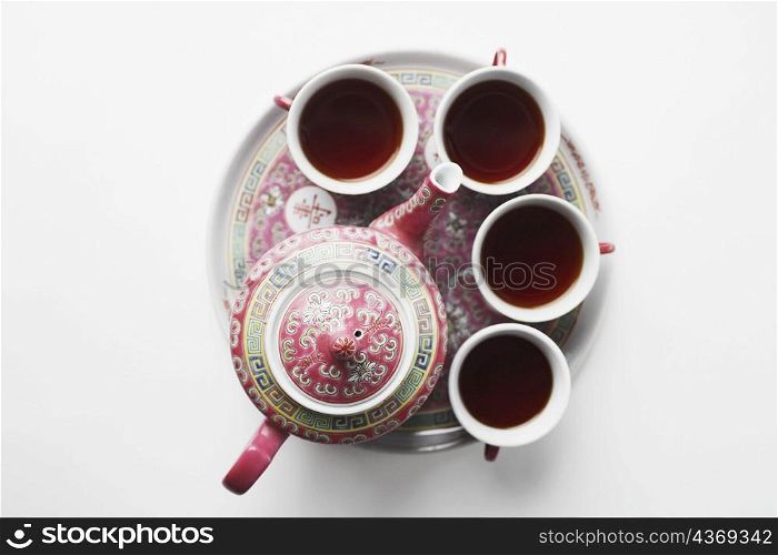 High angle view of tea cups with a teapot on a tray