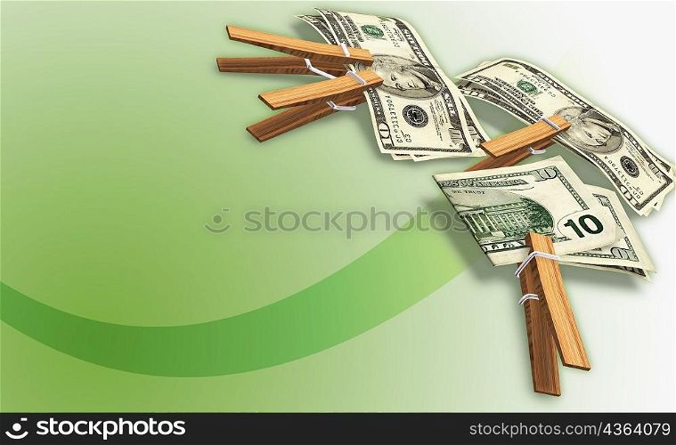 High angle view of ten dollar bills clipped with clothespins