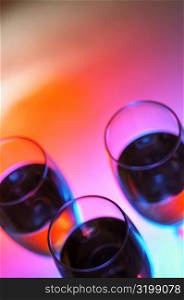 High angle view of three glasses of wine