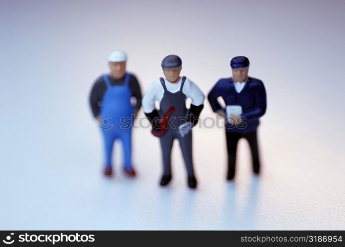 High angle view of three human figurines