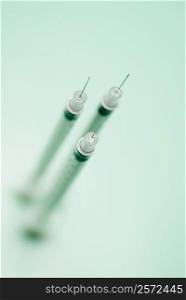 High angle view of three syringes