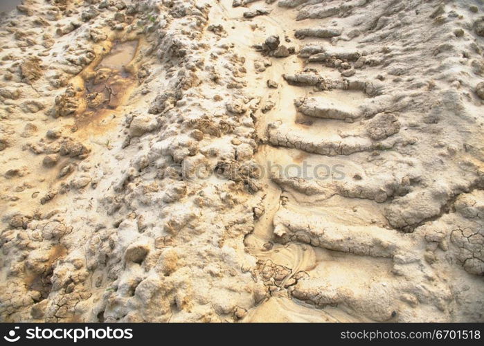 High angle view of tire tracks on a sandy surface