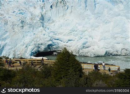 High angle view of tourists in front of a glacier, Moreno Glacier, Argentine Glaciers National Park, Lake Argentino, El Calafate, Patagonia, Argentina