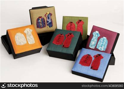 High angle view of traditional Chinese outfits embroidered on boxes