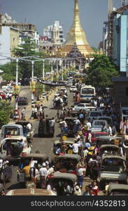 High angle view of traffic on the road with a pagoda in the background, Sule Pagoda, Yangon, Myanmar