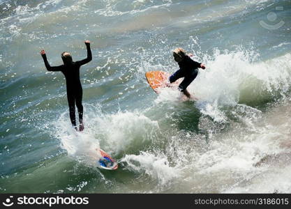 High angle view of two boogie boarders on the beach