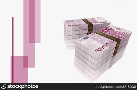 High angle view of two bundles of five hundred Euro bank notes