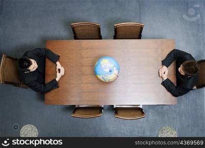 High angle view of two businessmen sitting at a conference table