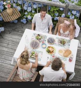 High angle view of two couples sitting at a dining table