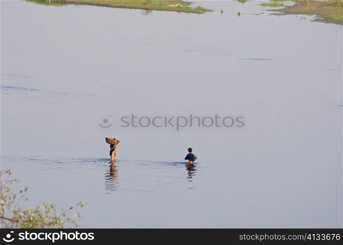 High angle view of two farmers crossing a river, Agra, Uttar Pradesh, India
