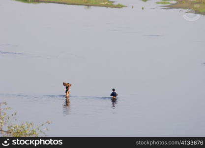 High angle view of two farmers crossing a river, Agra, Uttar Pradesh, India