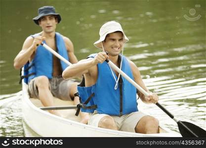 High angle view of two mid adult men boating in a river