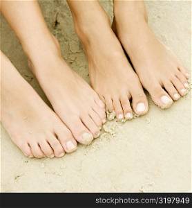 High angle view of two people bare feet