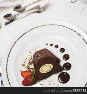 High angle view of two pieces of a chocolate cake with a strawberry in a plate
