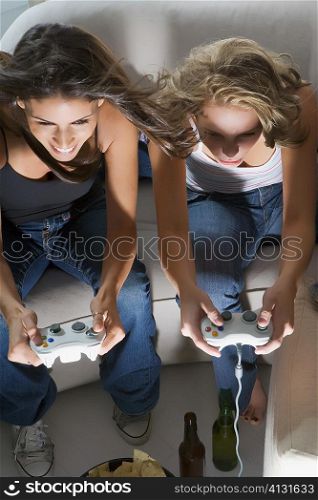 High angle view of two young women playing a video game together