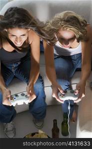 High angle view of two young women playing a video game together