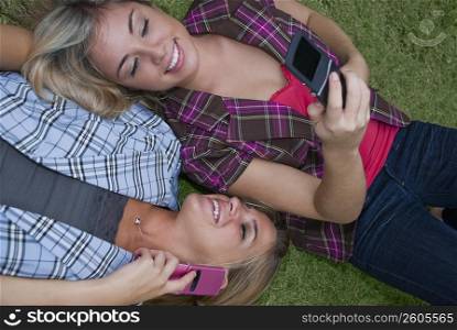 High angle view of two young women using mobile phones