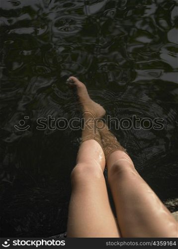 High angle view of woman&acute;s legs in water