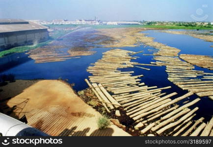 High angle view of wooden logs floating on water