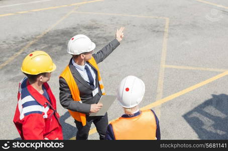 High angle view of workers discussing in shipping yard
