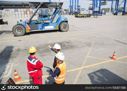 High angle view of workers discussing in shipping yard