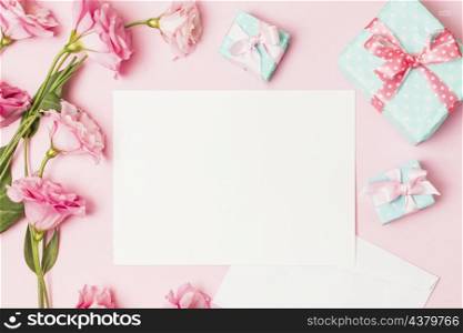 high angle view pink flower white blank paper decorative gift box