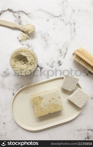 high angle view soap salt pumice stone brush marble surface