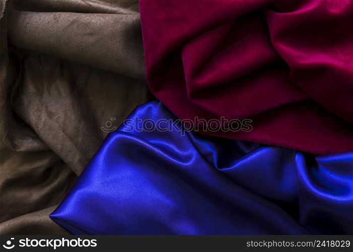high angle view three colorful silky drapes