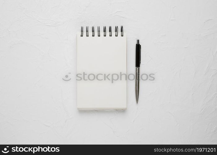 high angle view white blank spiral notepad with ballpoint pen. High resolution photo. high angle view white blank spiral notepad with ballpoint pen. High quality photo